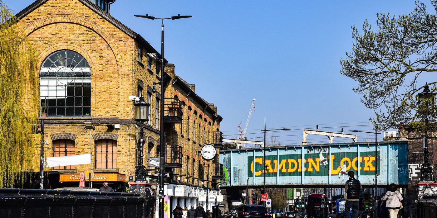 Camden Market signs and busy pedestrian street in London