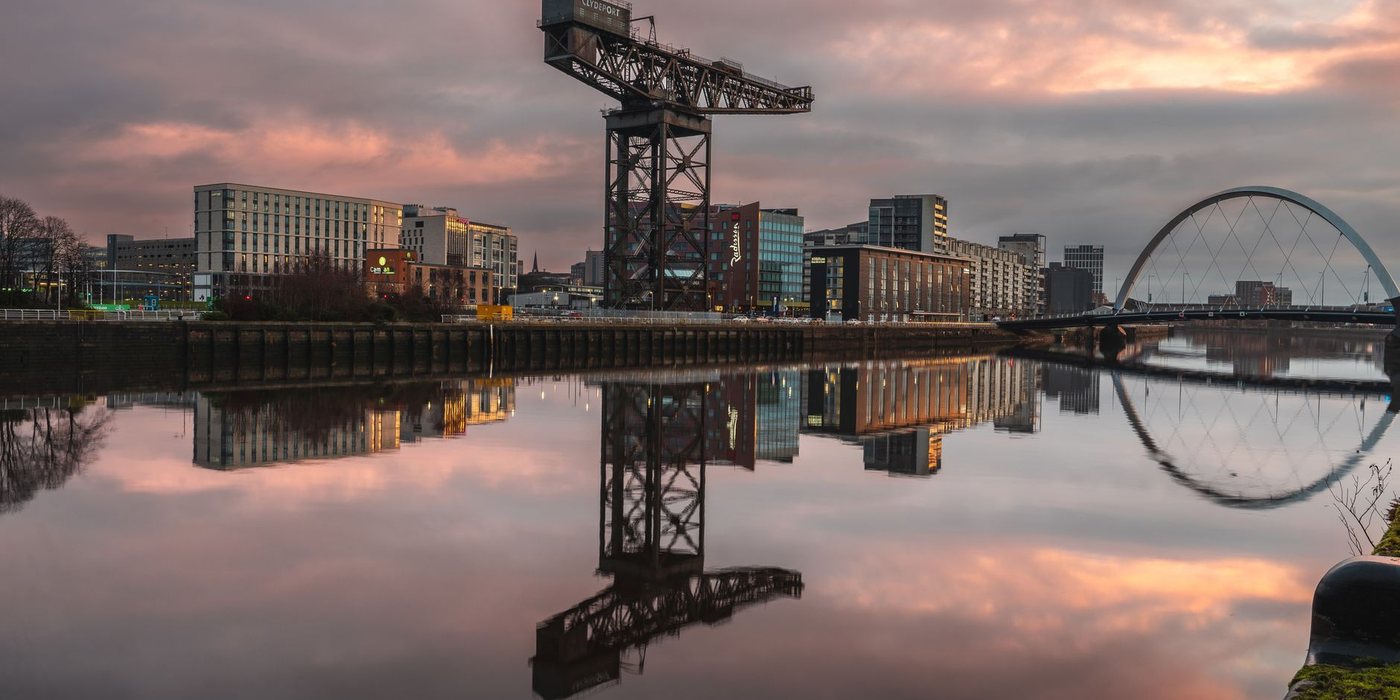 The Finnieston Crane and Clyde Arc bridge reflected in Glasgow's River Clyde at sunset